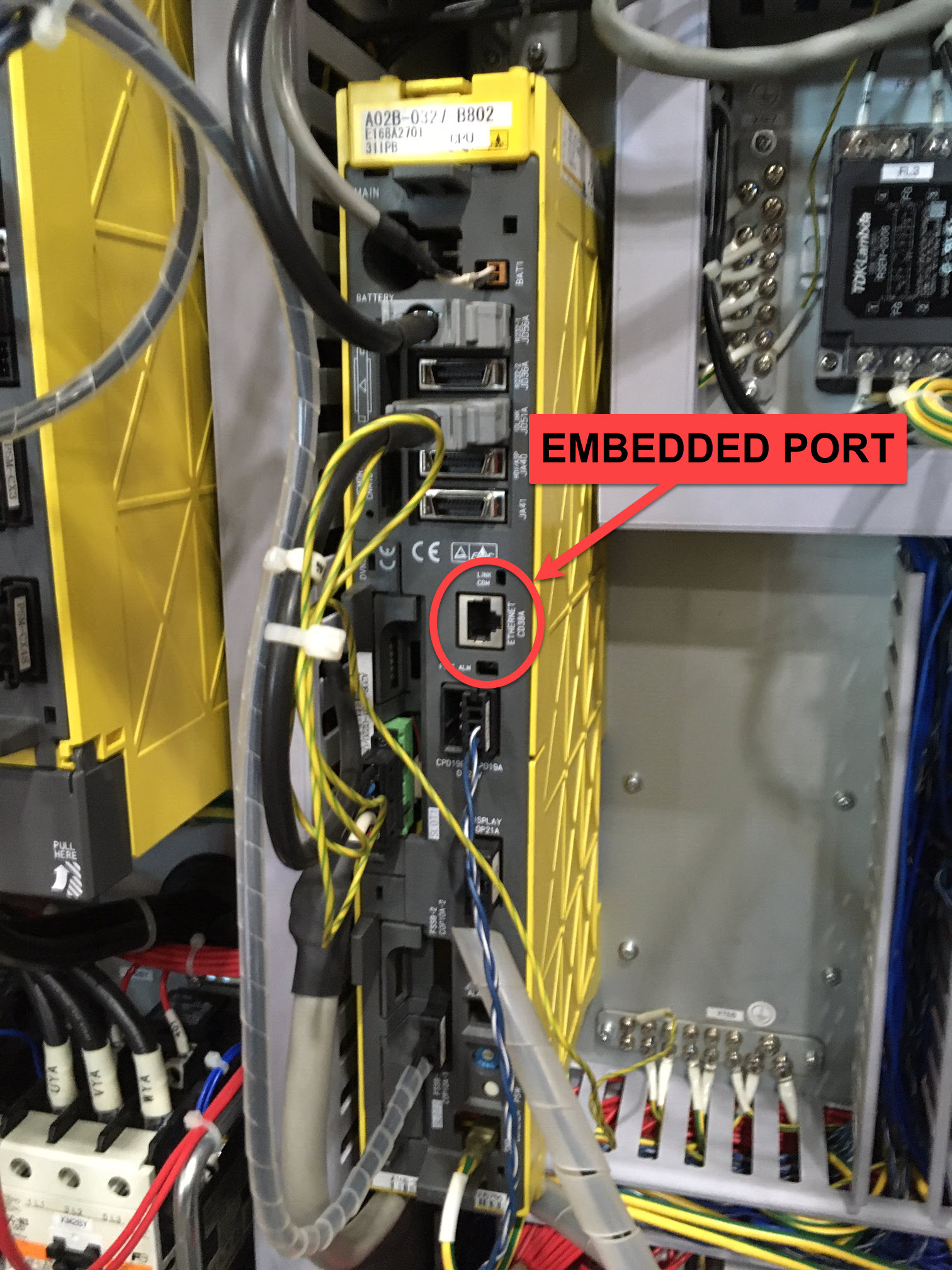 FANUC NCU embedded Ethernet port (A02B-0327 B802) close-up — RJ45 EMBEDDED PORT circled in red, located on the side of the yellow FANUC NCU module