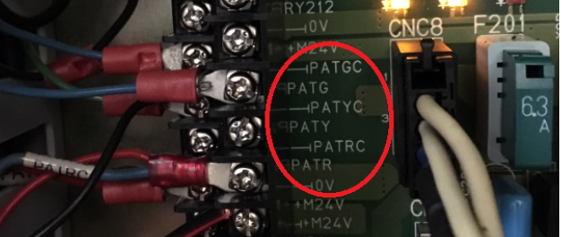 Citizen CNC8 terminal block showing PATGC (green), PATYC (yellow), PATRC (red) stack light output terminals — circled in red